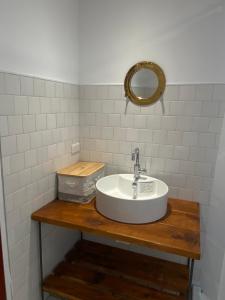 a bathroom with a sink and a mirror at Kenting Little House in Kenting