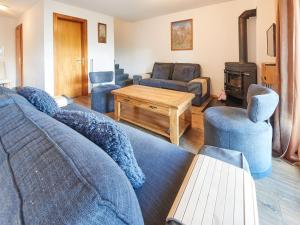 a living room with a couch and a table at Chalet Genepi by Interhome in Les Collons +11 photos