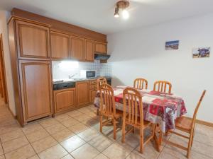 cocina con mesa y armarios de madera en Apartment Sérandes 2 by Interhome en Les Collons