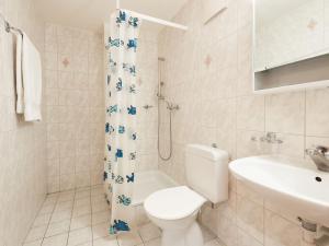 a white bathroom with a toilet and a sink at Apartment Sérandes 9 by Interhome in Les Collons