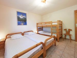 a bedroom with two bunk beds and a ladder at Apartment Sérandes 9 by Interhome in Les Collons