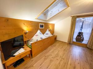 a living room with a couch and a television at Apartment Kramer by Interhome in Farchant