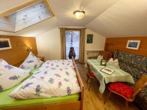 a small bedroom with a bed and a table at Apartment Kramer by Interhome in Farchant +20 photos