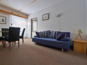 un soggiorno con divano blu e tavolo di Apartment Harrachovka - HRA102 by Interhome a Harrachov