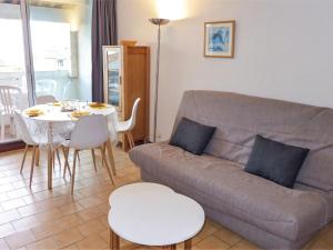 a living room with a couch and a table at Apartment Les Balcons de la Méditerranée-2 by Interhome in Narbonne-Plage