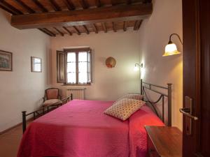 una camera con un letto con una coperta rossa di Apartment Giotto by Interhome a Montaione
