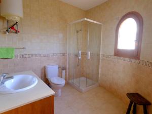 a bathroom with a sink and a shower and a toilet at Villa Rustical Mont Roig by Interhome in Miami Platja +23 photos