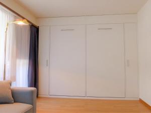 a living room with white cabinets and a couch at Apartment Milihaus A by Interhome in Zermatt