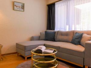 a living room with a couch and a table at Apartment Milihaus A by Interhome in Zermatt