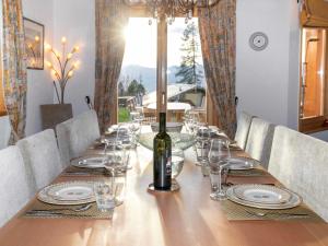a long wooden table with a bottle of wine on it at Chalet Chalet Petit Pont by Interhome in Villars-sur-Ollon