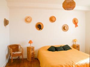 a bedroom with a bed and some hats on the wall at Holiday Home Passerat by Interhome in Maurs