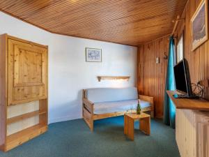 a bedroom with a bed and a television in a room at Apartment Le 2100 A et B-1 in Tignes