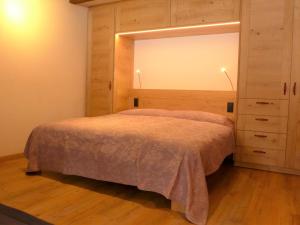 een slaapkamer met een bed en een grote spiegel bij Apartment Matten - Utoring-18 by Interhome in Zermatt