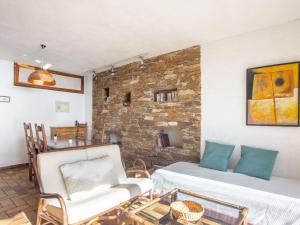 a living room with two chairs and a brick wall at Holiday Home Village Les Fourches by Interhome in Cabasson