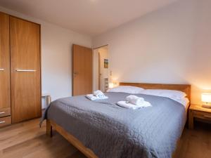 a bedroom with a bed with two towels on it at Apartment Alpenchalets - ZSE204 by Interhome in Zell am See