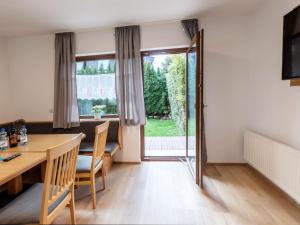 a dining room with a table and a large window at Apartment Alpenchalets - ZSE204 by Interhome in Zell am See