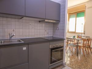 a kitchen with a sink and a table with chairs at Apartment Aurelia by Interhome in Rome