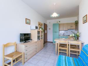 a kitchen and living room with a table and chairs at Apartment Albatros-1 by Interhome in Caorle +22 photos