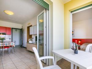 cocina y comedor con mesa y sillas en Apartment Robinia-Pinetine-1 by Interhome, en Duna Verde