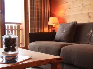 a living room with a couch and a coffee table at Apartment Grand-Hôtel B35 by Interhome in Villars-sur-Ollon
