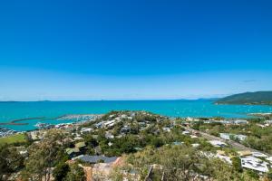 an aerial view of a city and the ocean at South Hamptons Beach House in Airlie Beach