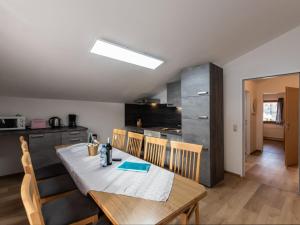 a kitchen and dining room with a table and chairs at Apartment Alpenchalets - ZSE203 by Interhome in Zell am See