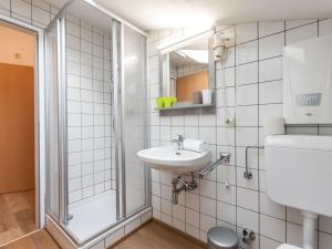 a white bathroom with a sink and a shower at Apartment Alpenchalets - ZSE203 by Interhome in Zell am See