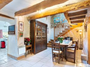 a dining room with a wooden table and chairs at Holiday Home La Duchesse by Interhome in Sarzeau
