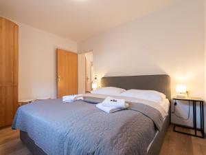 a bedroom with a large bed with two towels on it at Apartment Alpenchalets - ZSE201 by Interhome in Zell am See