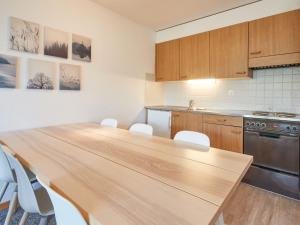 a kitchen with a long wooden table in a room at Apartment Hameau D1 by Interhome in Les Collons