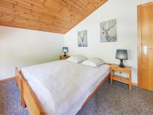 a bedroom with two beds and two lamps on tables at Apartment Le Hameau-7 by Interhome in Les Collons