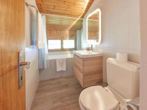 a bathroom with a toilet and a sink at Apartment Le Hameau-7 by Interhome in Les Collons
