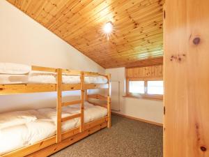 two bunk beds in a room with a wooden ceiling at Apartment Le Hameau-7 by Interhome in Les Collons +12 photos