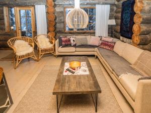 a living room with a couch and a coffee table at Holiday Home Kantolan veska by Interhome in Ruka