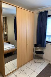 a bedroom with a sliding door and a mirror at Apartment Witthuus-Borkum by Interhome in Norddeich