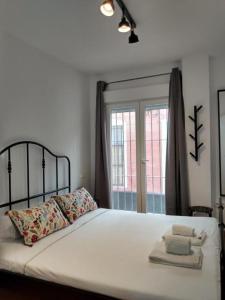 een slaapkamer met een bed met handdoeken erop bij CDZ - San Telmo, apartamentos con terraza in Cádiz