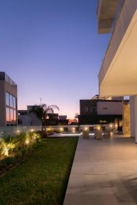 a courtyard of a building at night with lights at Sea Pearl Beachfront Villas - Breeze in Ayia Napa