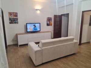 a living room with a couch and a flat screen tv at La Zagara home in Villabate