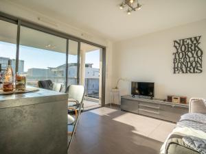 a kitchen and living room with a view of the city at Apartment Rive Gauche by Interhome in Fréjus