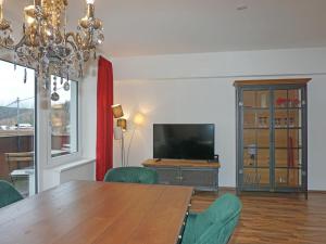a dining room with a table and a television at Apartment Isolde by Interhome in Reith bei Seefeld