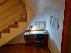 - un bureau avec un ordinateur dans une chambre avec des escaliers dans l'établissement Duplex da Fontinha, à Santa Cruz