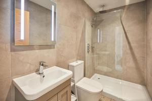 a bathroom with a sink and a toilet and a shower at Host & Stay - 2 Maritime Apartments in Scarborough