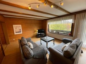 a living room with a couch and a table at Holiday Home Ferienpark Himmelberg-5 by Interhome in Thalfang