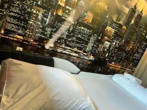 a bedroom with a view of a city skyline at NEW - Bat'Appart - DIJON - Insolite in Longvic