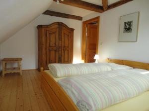 1 dormitorio con 1 cama y armario de madera en Lindenhof en Murau