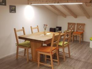 a dining room with a wooden table and chairs at Apartment Lischa by Interhome in Fiesch