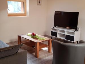a living room with a tv and a coffee table at Apartment Lischa by Interhome in Fiesch