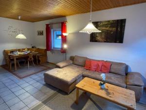 a living room with a couch and a table at Holiday Home Ferienpark Himmelberg-8 by Interhome in Thalfang