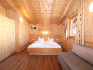 a bedroom with a bed in a wooden cabin at Chalet Chalet Elisabeth by Interhome in Juns