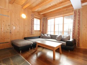 a living room with a couch and a coffee table at Chalet Chalet Elisabeth by Interhome in Juns